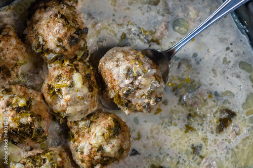 Hommade roasted delicious meatballs in cream sauce. Close up view. photo