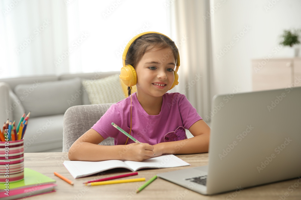 Distance learning, studying at home. Girl having online school lesson during quarantine and lockdown due to Covid-19 pandemic Distance learning, studying at home. Girl having online school lesson during quarantine and lockdown due to Covid-19 pandemic