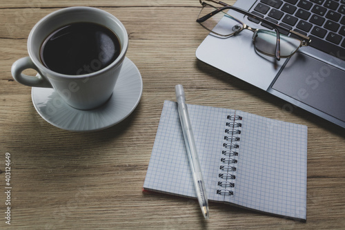 Foto Conceptual workspace wood texture background,  laptop, keyboard, cup of coffee a