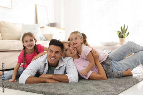 Happy family with children on floor at home