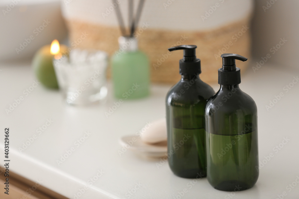 Green soap dispensers on white countertop in bathroom. Space for text Green soap dispensers on white countertop in bathroom. Space for text