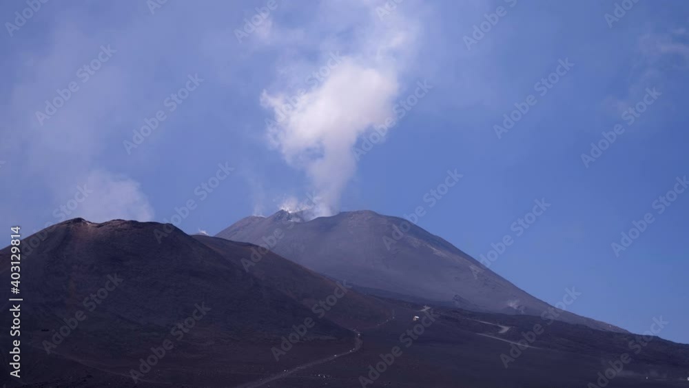 magnificent view of etna with the smoke coming out of the crater magnificent view of etna with the smoke coming out of the crater