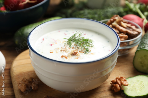 Delicious cold summer soup on wooden board, closeup