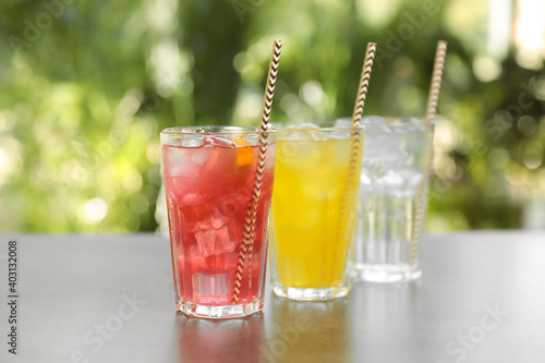 Bild auf Leinwand Delicious refreshing drinks in glasses on grey table outdoors