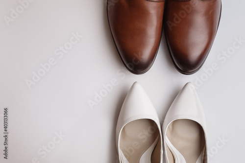 Wedding shoes for bride and groom on white background, top view