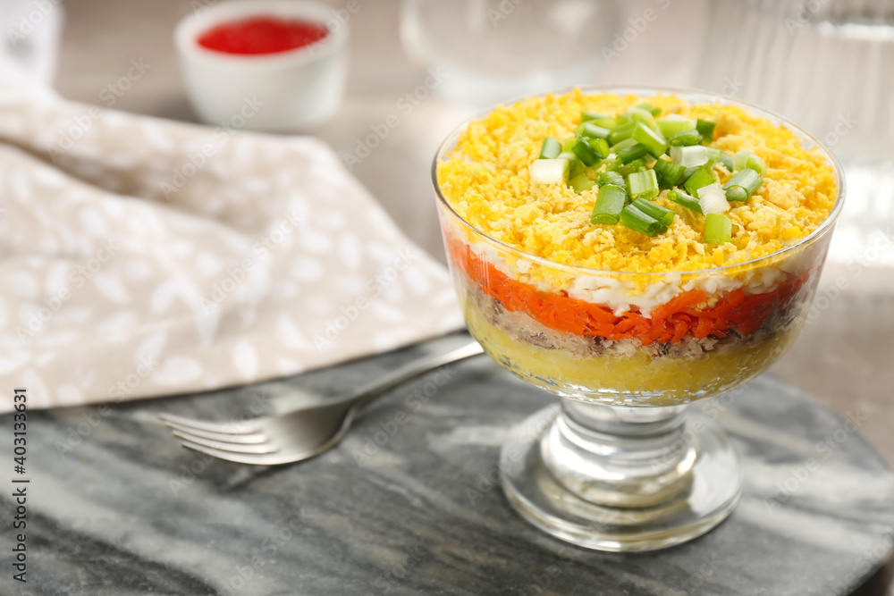 Traditional russian salad Mimosa in bowl on grey board, closeup. Space for text Traditional russian salad Mimosa in bowl on grey board, closeup. Space for text