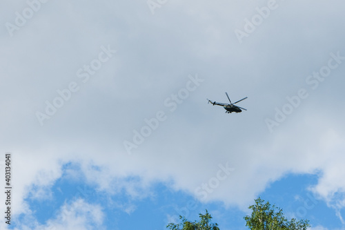 helicopter on a background of blue sky with clouds
