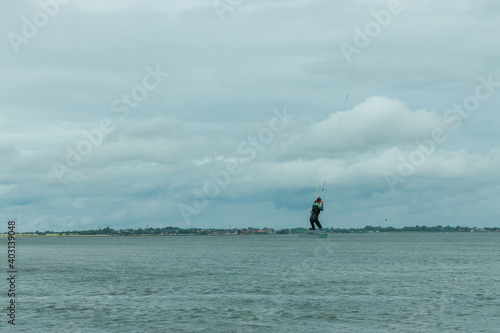 kitesurfer flies across the sky of the North Sea in Germany