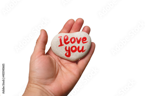 stone in shape of heart with inscription written by hand I love you on female palm on white background