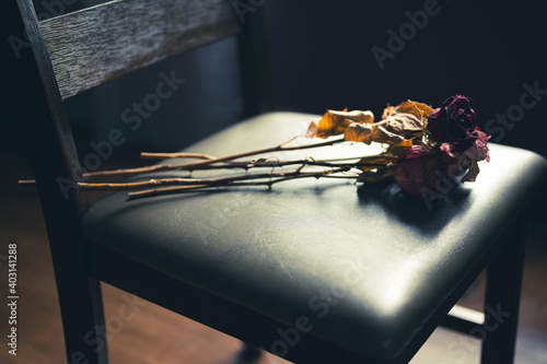 preserved roses on a chair in an empty house