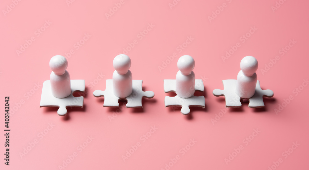 People figures on puzzles on pink background,human resources and management concept People figures on puzzles on pink background,human resources and management concept