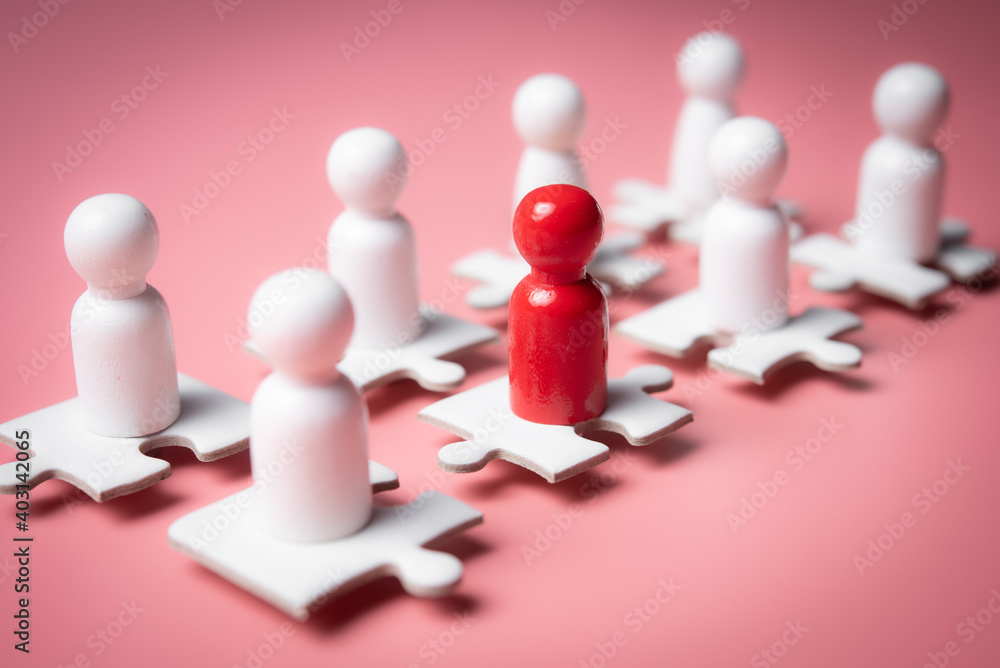 People figures on puzzles on pink background,human resources and management concept People figures on puzzles on pink background,human resources and management concept