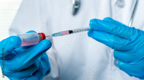 Doctors or scientists are carrying syringes with liquid vaccines for young and old to. prevent COVID-19 in the laboratory. Concept COVID-19 vaccine.