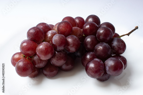 Bunch of red globe grapes isolated on white background
