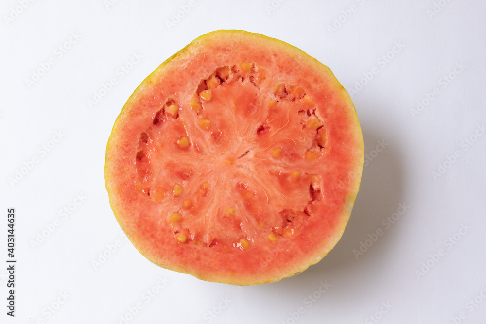 Red guava cut in half, showing the seeds and isolated on white background Red guava cut in half, showing the seeds and isolated on white background