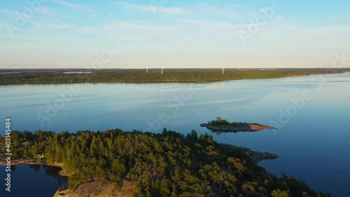 Aerial view wind power mills on a island, sunset, in the Finnish Archipelago - dolly, drone shot photo