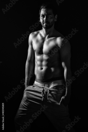 portrait on dark background of muscular young model man