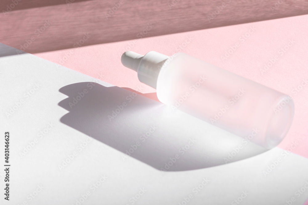 Serum oil with collagen and peptide in white transparent bottle with dropper on pink backdrop with shadows. Skincare beauty treatment medical skincare mockup packaging liquid cosmetic product Serum oil with collagen and peptide in white transparent bottle with dropper on pink backdrop with shadows. Skincare beauty treatment medical skincare mockup packaging liquid cosmetic product