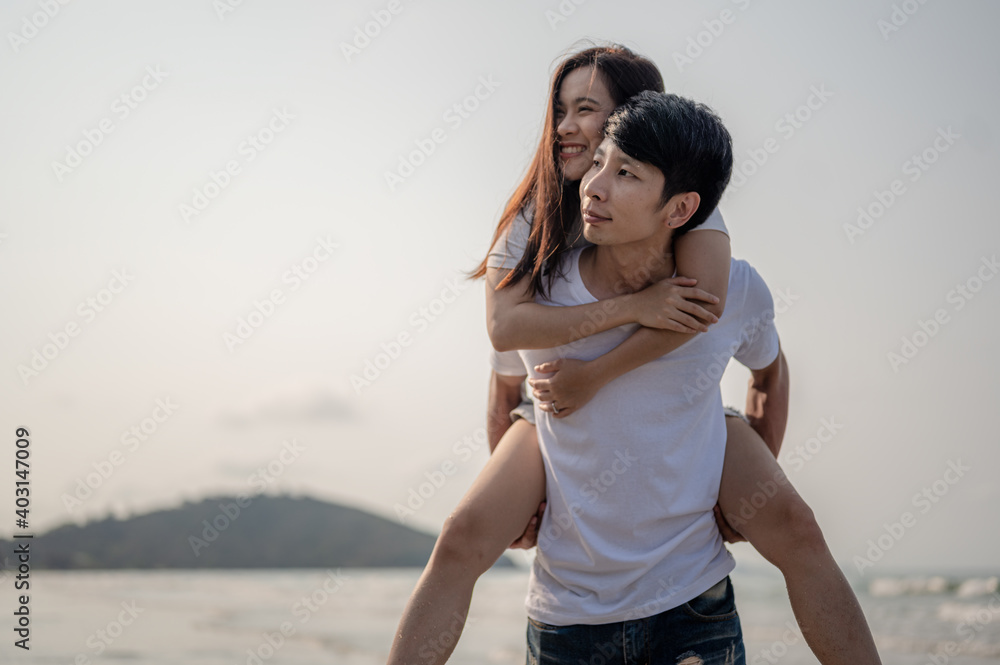 Young couple in love on beach summer vacations. Joyful girl on young boyfriend having fun.Summer in love,Valentine day concept. Young couple in love on beach summer vacations. Joyful girl on young boyfriend having fun.Summer in love,Valentine day concept.