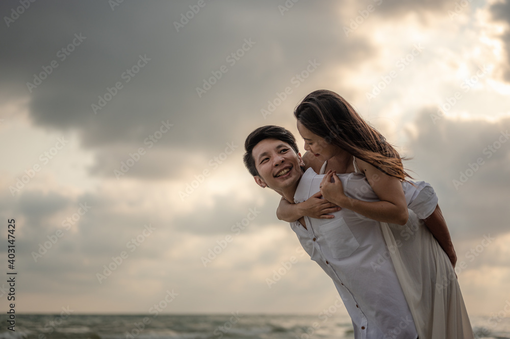 Portrait couple in love on beach summer vacations. Joyful girl on young boyfriend having fun.Summer in love,Valentine day concept. Portrait couple in love on beach summer vacations. Joyful girl on young boyfriend having fun.Summer in love,Valentine day concept.