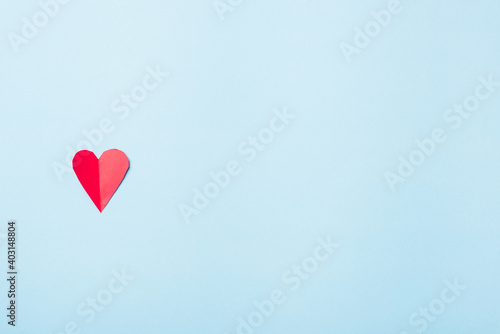 Valentines' day background. Beautiful red paper hearts cut composition greeting card isolated on blue background with copy space, Symbol of love Top View from above