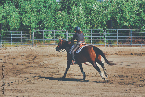 A rider drives his horse during a equestrian competition