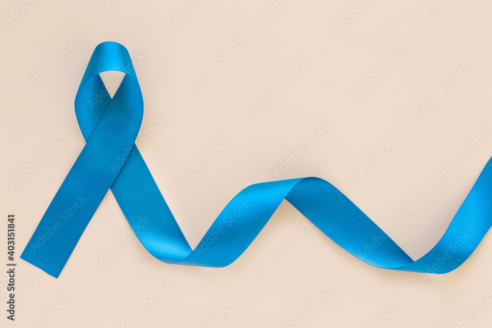 Teal color ribbon curl on white or beige isolated background, copy