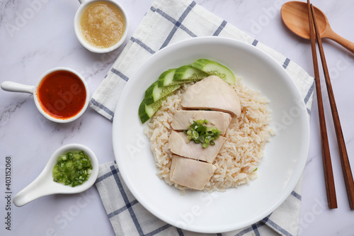 Hainanese Chicken over the fragrant oily rice and three kind of sauces - Famous Singaporean food and in Thai called Khao Mun Gai
