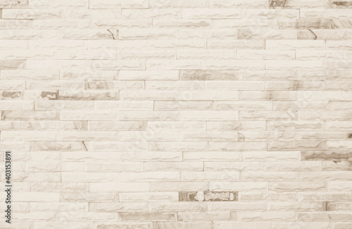 Empty Background of wide cream brick wall texture. Old brown brick wall concrete or stone pattern nature, wallpaper limestone abstract floor/Grid uneven interior rock. Home & office design backdrop.
