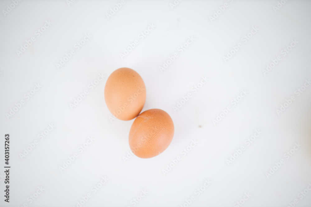 Two eggs isolated on a white table from above Two eggs isolated on a white table from above
