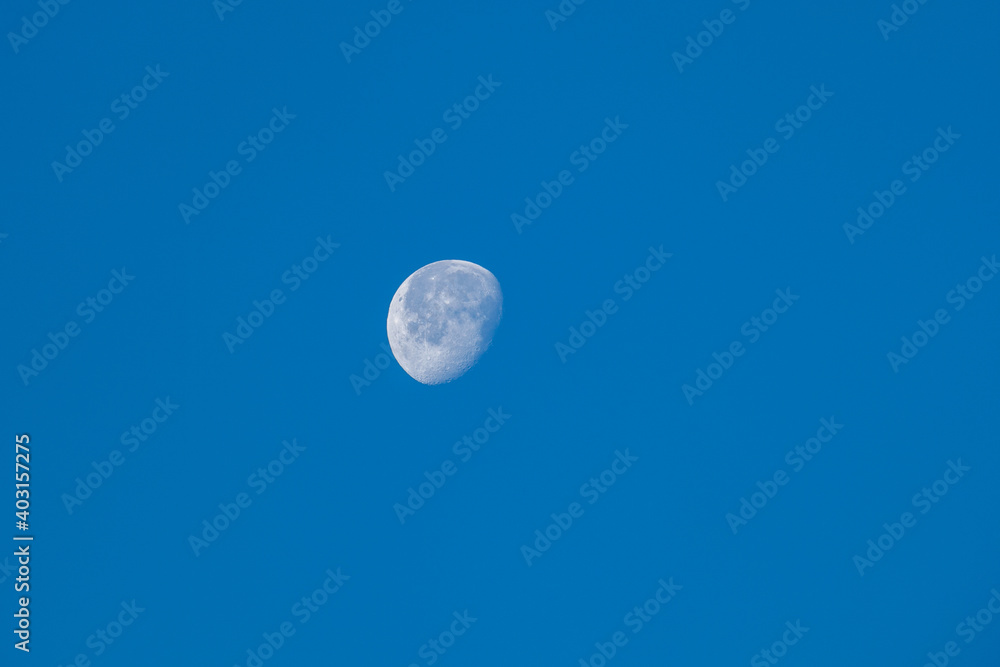 young moon on light blue sky, half moon young moon on light blue sky, half moon