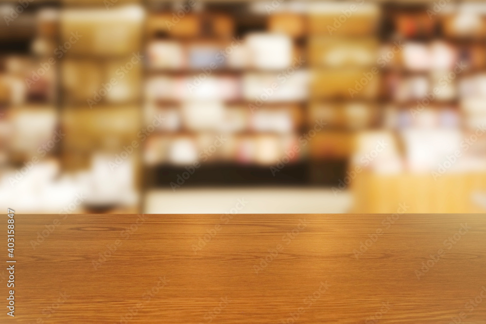Top of empty of wood table with Blurred background of modern bookstore and stationary store interior. Using for Mock up template for craft display of your design,Banner for advertise.