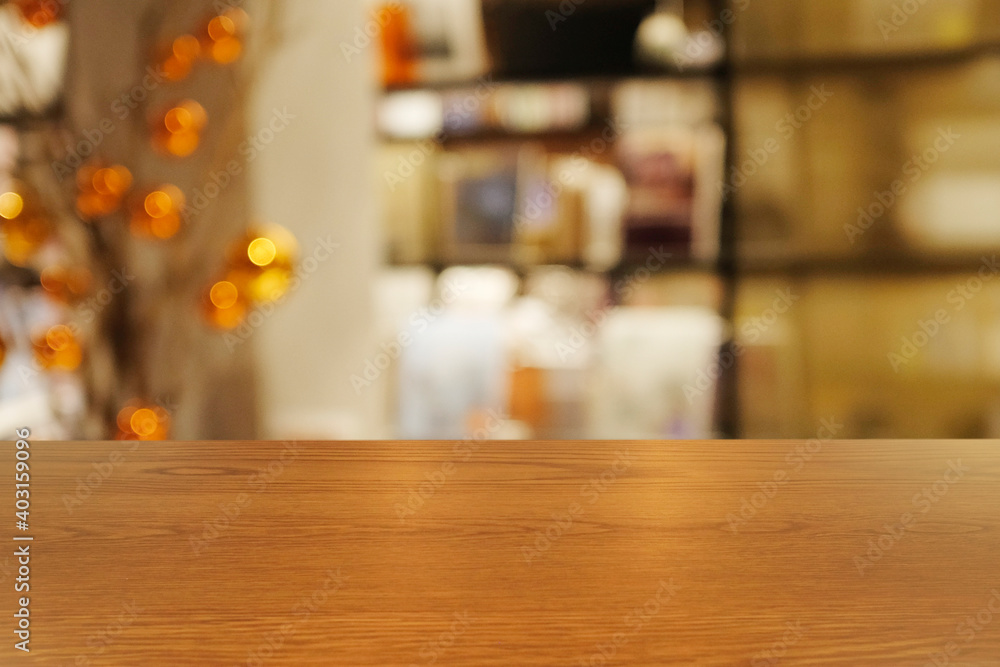 Top of empty of wood table with Blurred background of modern bookstore and stationary store interior. Using for Mock up template for craft display of your design,Banner for advertise.