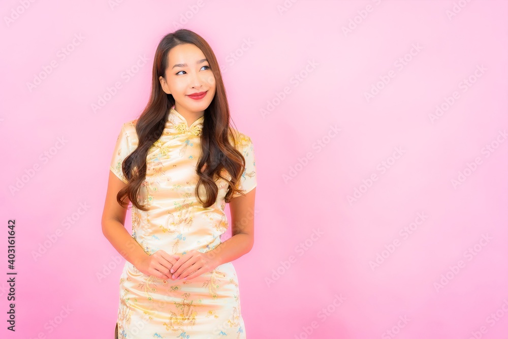 Portrait beautiful young asian woman smile in action with chinese new year concept Portrait beautiful young asian woman smile in action with chinese new year concept