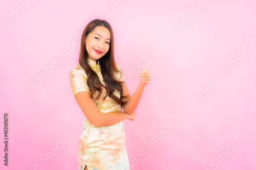 Portrait beautiful young asian woman smile in action with chinese new year concept