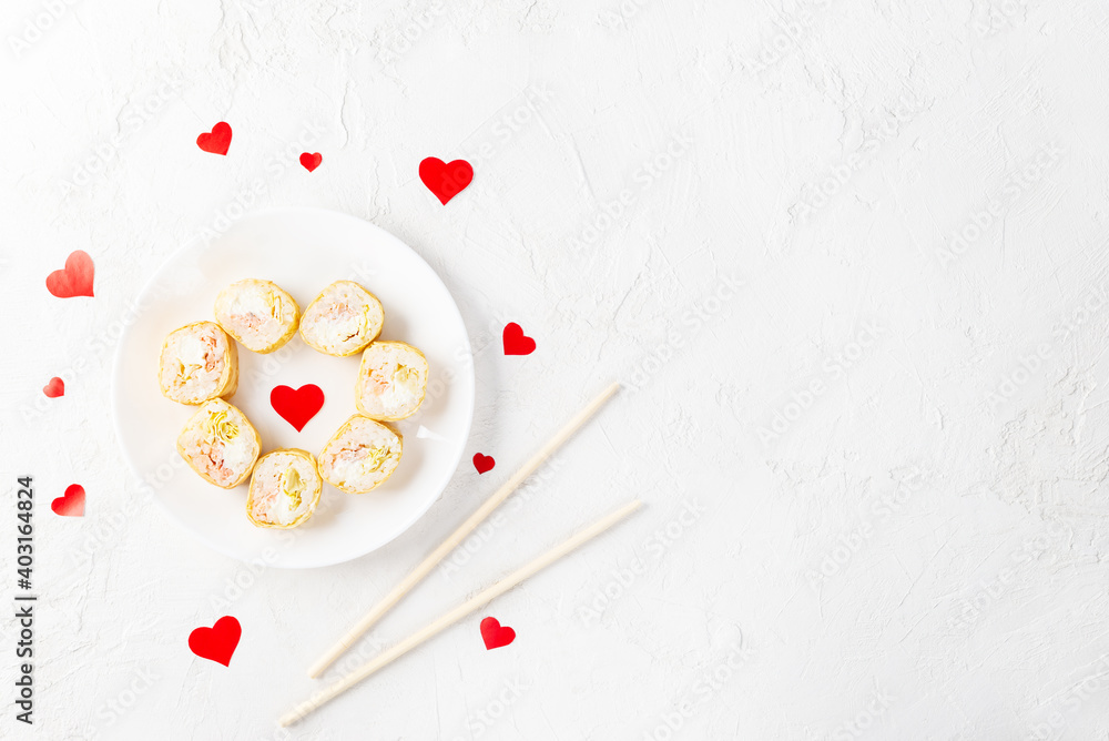 Sushi rolls for Valentine's Day with red hearts on a white plate. Horizontal orientation, copy space. Sushi rolls for Valentine's Day with red hearts on a white plate. Horizontal orientation, copy space.