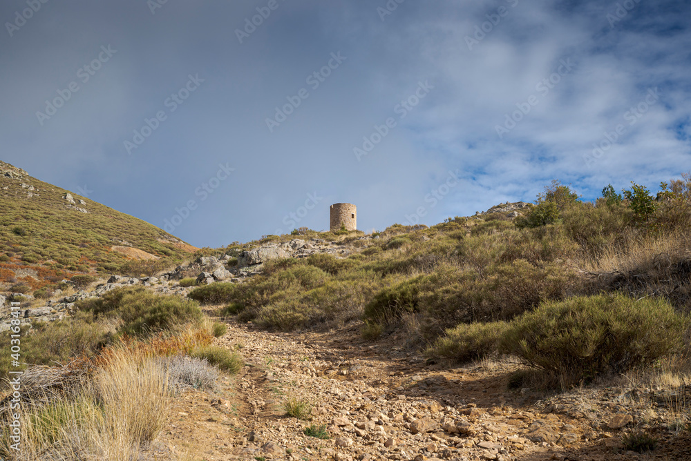 Old wind mill for mineral grinding. Its construction began in the year 1.659. Photo taken in the abandoned silver mine located in the municipality of Bustarviejo, province of Madrid, Spain