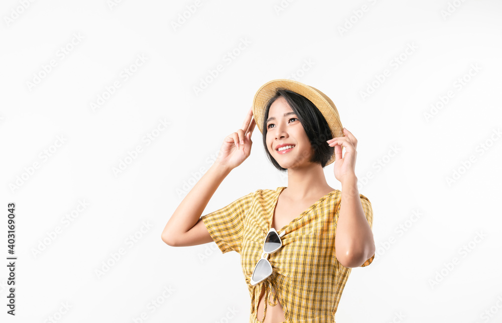 Studio shot of cheerful beautiful Asian woman in yellow color dress and wearing a hat and stand on white background. Studio shot of cheerful beautiful Asian woman in yellow color dress and wearing a hat and stand on white background.
