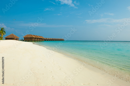 Beach view with water villas on Maldives island © galika