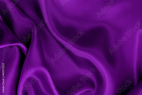 Dark purple fabric texture background, detail of silk or linen pattern.