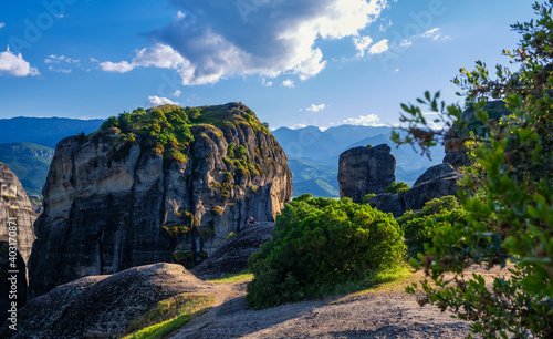 Evening view of typical Meteora landscape, Greece. Massive sedimentary rocks, cliffs, mountains, valley. Blue sky and great clouds. Selective focus.