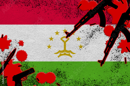 Tajikistan flag and guns in red blood. Concept for terror attack and military operations photo