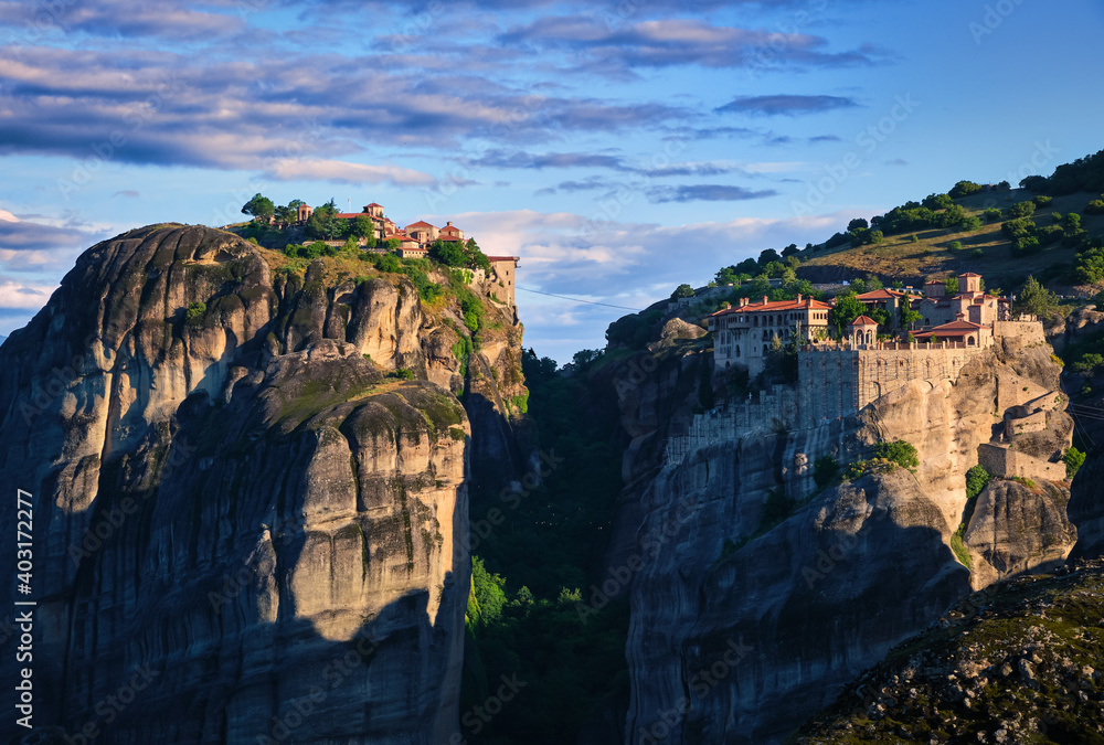 Early morning over Varlaam and Great Meteoron or Megalo Meteoro or Metamorphisis monasteries in Meteora, Greece. First sun rays. UNESCO World Heritage