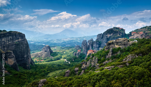 View on massive rocky pillars of Meteora, Thessaly, Greece. Nunnery of Moni Agias Varvaras Roussanou and Varlaam monastery. Sun rays over valley