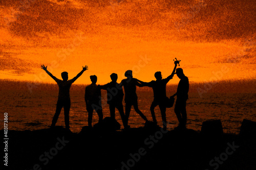 people on the beach at sunset