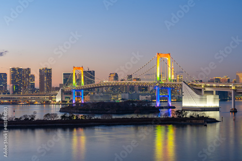 Fototapeta Tokyo skyline at night with view of Rainbow bridge in Japan