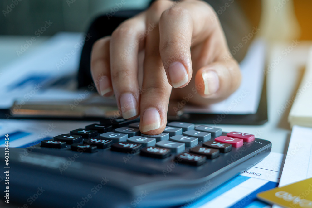 Businessmen use a calculator to calculate income and expenses in order to manage budgets to pay off credit card debt. Businessmen use a calculator to calculate income and expenses in order to manage budgets to pay off credit card debt.