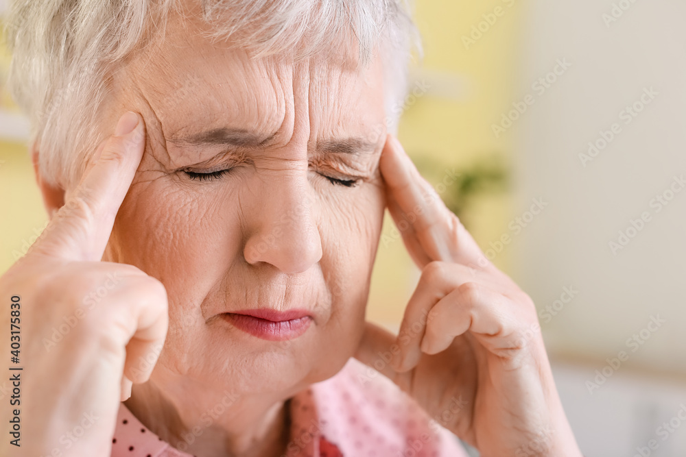 Stressed senior woman suffering from headache Stressed senior woman suffering from headache