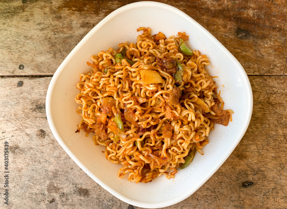 indonesian instant noodle served in white bowl. indonesian instant noodle served in white bowl.