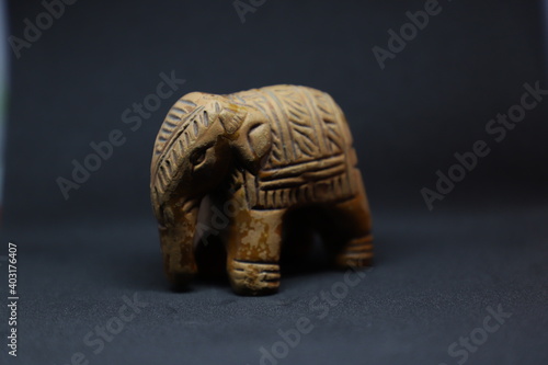 Terra Cotta baby common elephant show piece over black background 